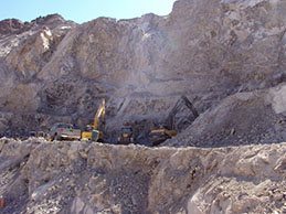 Quarry face with an excavator at work